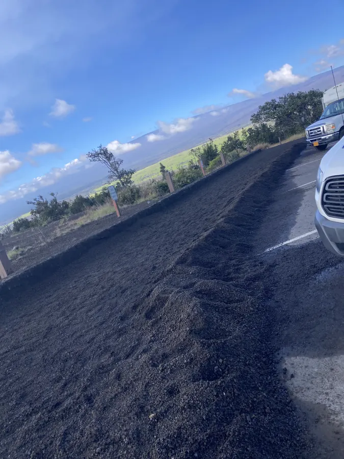 An Aloha ʻĀina Tours van on a Big Island lava-rock road