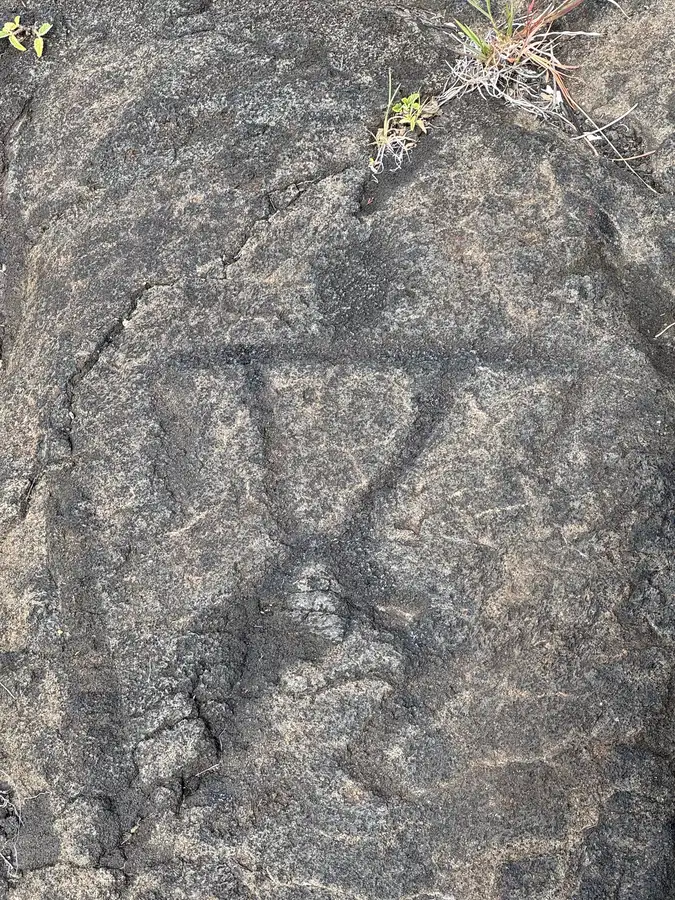 A Hawaiian petroglyph figure etched into stone